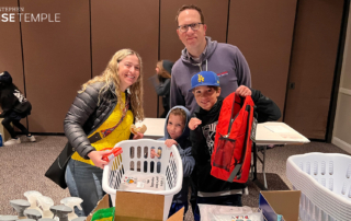 Sam and Elina Wineburgh and their sons help package "welcome home" boxes for LA Family Housing before the Purimland Purim Carnival at Stephen Wise Temple on March 5, 2023. (Photo by Rabbi Ron Stern)