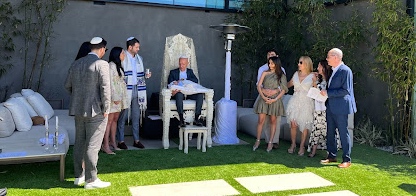 Rabbi Ron Stern attends the baby naming of his grandchild.