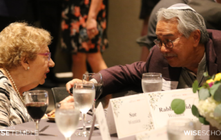 Sue Woznica, mother of Stephen Wise Temple's Rabbi David Woznica, converses with Wise Board member Jim Leewong at Board Installation Shabbat in Zeldin-Hershenson Hall on June 16, 2023. (Photo by Raz Husany)