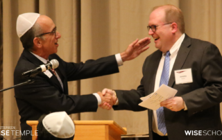 Outgoing Stephen Wise Temple Board President Steve Bram installs his successor, Jeremy Rosen, on June 16, 2023, in Zeldin-Hershenson Hall. (Photo by Raz Husany)